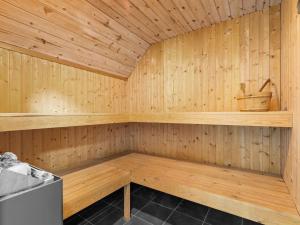 a sauna with wooden walls and a wooden floor at Holiday Home Erle - 830m from the sea by Interhome in Nyby