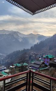 a view of a town with mountains in the background at Iris cafe and cozy stay in Tosh +8 photos