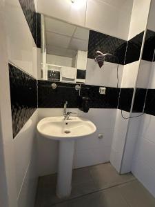 a bathroom with a sink and a mirror at İzmir homes in Buca