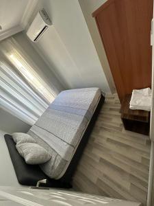 a bed in a small room with a window at İzmir homes in Buca