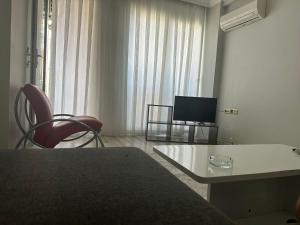 a living room with a table and chairs and a television at İzmir homes in Buca