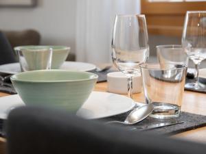 a table with a bowl and glasses on a table at Apartment La Siala Apt-7 by Interhome in Falera +49 photos