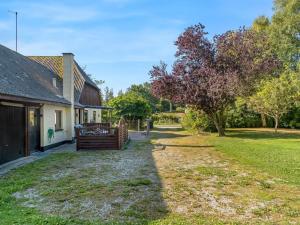 a yard next to a house with a tree at Holiday Home Eiko - 400m to the fjord by Interhome in Storvorde
