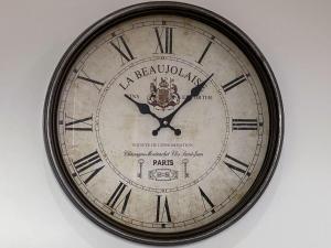 a clock with roman numerals on a wall at Apartment Forres View by Interhome in Forres