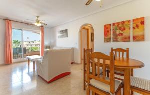a living room with a table and a dining room at Great Apartment Orihuela Costa in Villamartin