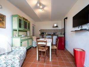 a living room with a table and a kitchen at Holiday Home Casetta di Agnese by Interhome in San Damiano dʼAsti