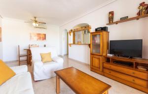 a living room with a tv and a couch at Great Apartment Orihuela Costa in Villamartin