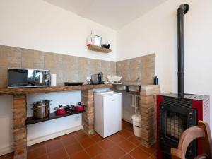 a kitchen with a refrigerator and a stove at Holiday Home Casetta di Agnese by Interhome in San Damiano dʼAsti +19 photos