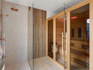a bathroom with a glass shower and a glass door at Holiday Home Merve - 250m from the sea by Interhome in Odder