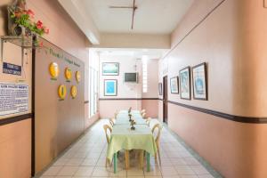 a long dining room with a table and chairs at GV Hotel - Masbate in Masbate