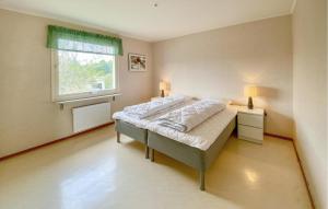 a bedroom with a large bed with a window at Beautiful Apartment In Pauliström in Pauliström