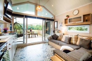 a living room with a couch and a large window at Hillside Lodge in Nantmel