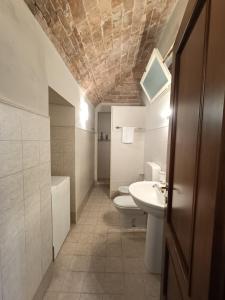 a bathroom with a toilet and a sink at Via Angelo Brofferio - Appartamento Centro Storico in Asti