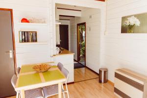 a kitchen and dining room with a table and chairs at Retro mobilehome Buurgplaaz in Wintger