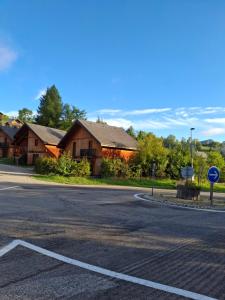 an empty road in front of some wooden buildings at studio gresse en vercors in Gresse-en-Vercors