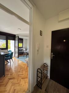 a living room with a door and a dining room at Stan na dan Brena in Foča