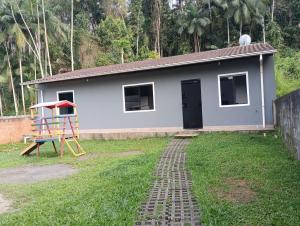 a small house with a playground in front of it at Casa Blumenau in Blumenau