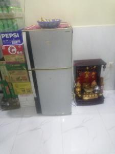 a small refrigerator next to a box of food at Homestay Srey Mom in Kampot