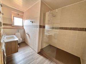 a bathroom with a shower and a sink and a toilet at Chambre double dans Auberge Alsacienne in Scherwiller +37 photos