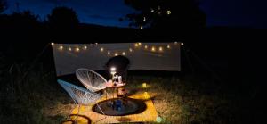 a table with two chairs and a candle on it at night at Jur Georgious in Svätý Jur