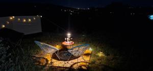 a table with a candle in the grass at night at Jur Georgious in Svätý Jur