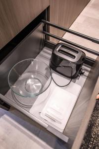a cell phone and a bowl on a shelf at Jacuzzi Cinema Shibui 5 in Kaunas +22 photos
