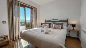 a bedroom with a large bed with a large window at Guils Cal Peiró in Guils de Cerdaña