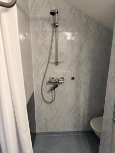 a bathroom with a shower with a shower head at Arctic River Apartment in Rovaniemi +47 photos