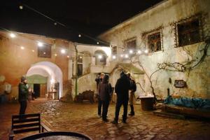 a group of people standing outside of a building at night at Jur Georgious in Svätý Jur