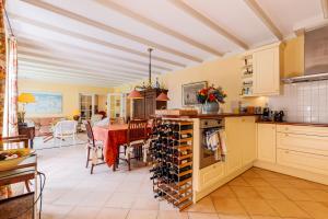 a kitchen with a table with a bunch of wine bottles at Vrijvakantiehuis Herenhof in Domburg