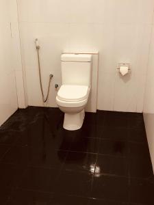 a bathroom with a white toilet in a stall at Ramira Holiday Bungalow in Moragaswewa +15 photos