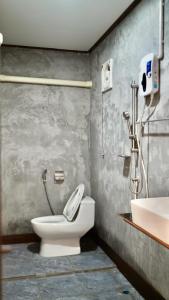 a bathroom with a toilet and a sink at Baan Gamnan Resort - Ao Luek in Ban Khao Ngam