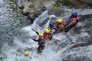 a group of people are rafting on a waterfall at Kelani Riverside Retreat in Kitulgala +4 photos