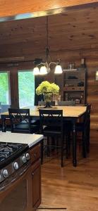 a kitchen with a table with chairs and a stove at The Lodge at Coker Creek in Coker Creek