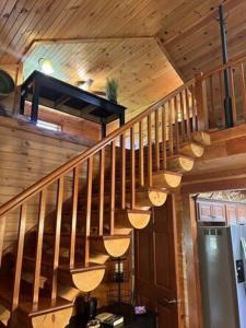 a wooden staircase in a house with a light at The Lodge at Coker Creek in Coker Creek