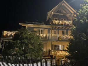 a building with a balcony with lights on it at Apartment with charm and dream view in Hosenruck