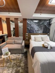 a hotel room with two beds and a couch at Mitch serene shore in Manila