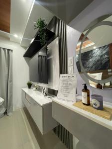 a bathroom with a sink and a mirror at Mitch serene shore in Manila
