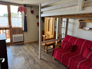 a living room with a couch and a loft bed at Studio La Plagne Villages in La Plagne Tarentaise