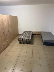 a room with two beds and cabinets in it at Hostel TV in Trebišov