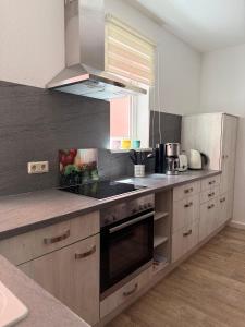 a kitchen with a sink and a stove top oven at Ferienwohnung Schmücke zum Prinzenweg in Oberhof