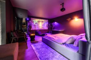 a purple bedroom with a large bed with a purple ceiling at Jacuzzi Cinema Japandi 2 in Kaunas