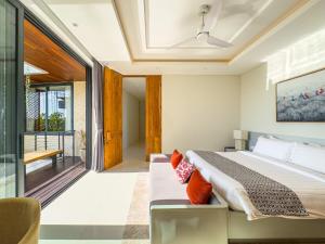 a bedroom with a bed and a balcony at Narawangsa Villa 4br Amazing Sunset Rooftop in Kerobokan +130 photos