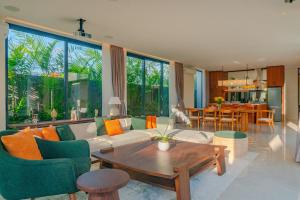 a living room with a couch and a table at Narawangsa Villa 4br Amazing Sunset Rooftop in Kerobokan