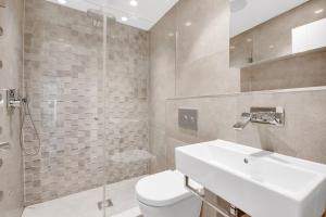 a bathroom with a toilet and a sink and a shower at Blueground Fitzrovia spa nr Oxford St LON-178 in London
