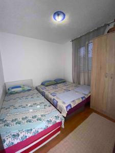 a bedroom with two beds in a room at Milun Stan in Sutomore