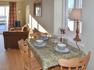 a living room with a table and chairs and a dining room at Calf House Cottage in Sedgefield
