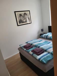 a bedroom with a bed with a picture on the wall at Fridolin in Reichenbach im Vogtland