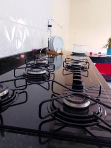 a stove top with a bunch of burners on it at Luxury caiçara house in Paraty in Paraty