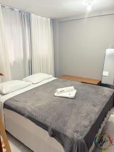 a bedroom with a bed with a towel on it at Paradise Flat 412 in Nossa Senhora do Livramento +11 photos
